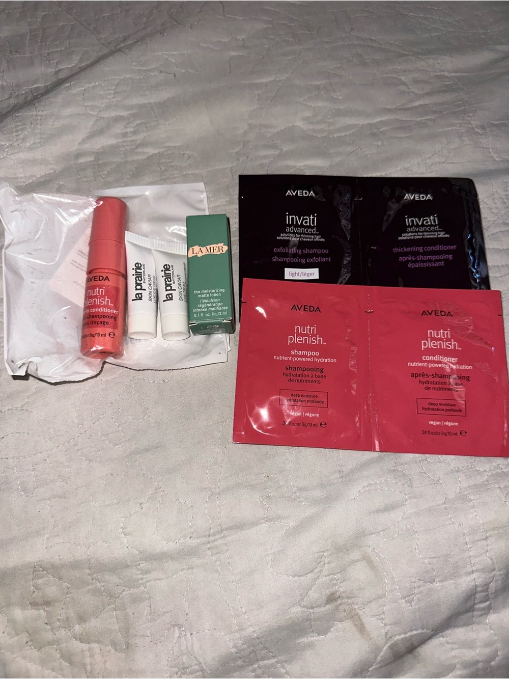 AVEDA NutriPlenish coral and black sample sachets